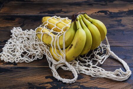 Fresh bio bananas in eco mesh bagの写真素材