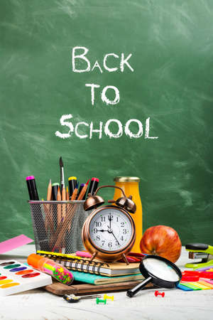 School statonery on green blackboardの写真素材