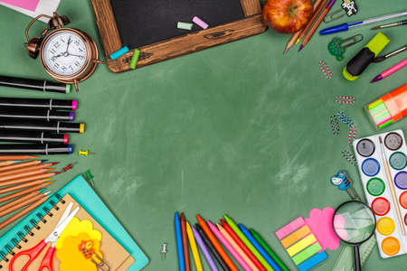 School statonery on green blackboardの写真素材