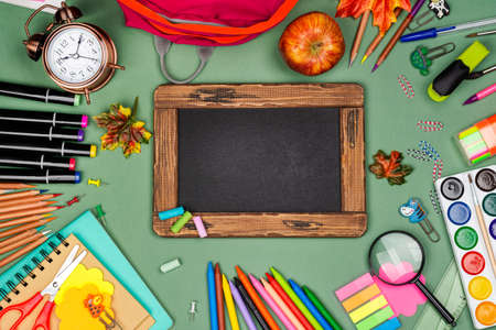 School statonery on green blackboardの写真素材