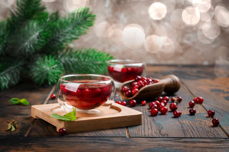 Hot cranberry tea on wooden tableの写真素材
