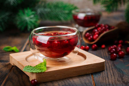 Hot cranberry tea on wooden tableの写真素材
