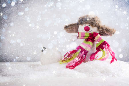Happy snowman in a funny hatの写真素材