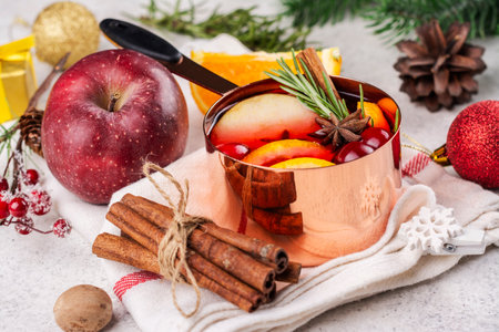 Hot mulled wine with fruits and spices in a copper potの写真素材
