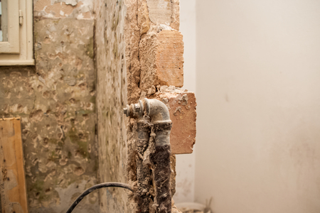 Flat renovation, master crashes in the bathroom wall where the pipes of waterの写真素材