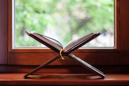 Quran-holy book of Muslims, an open book on a stand with rosaryの写真素材