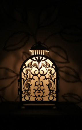 Lit candles in beautifully carved cage, beautiful decoration to place candles, lightの写真素材