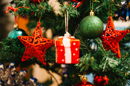 Christmas decoration on fir, red star hanging like decoration on fir, holidays are coming, Christmas and New Yearの写真素材