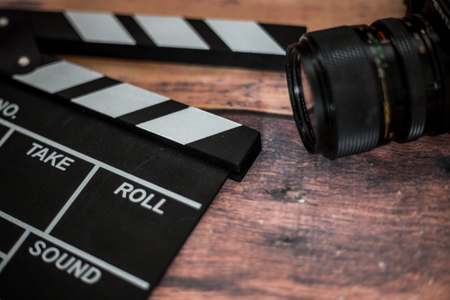 Movie clapper and old camera on a wooden background, movie shooting, film, screenplay, directorの写真素材