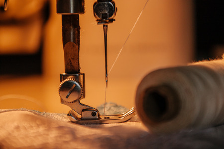 Sewing machine, sewing process, thread next to machines, pause to replace the thread, fabric is stitchedの写真素材