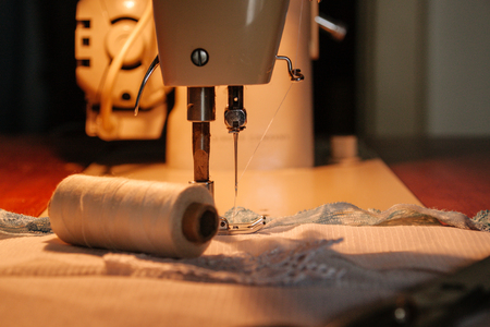 Sewing machine, sewing process, thread next to machines, pause to replace the thread, fabric is stitchedの写真素材