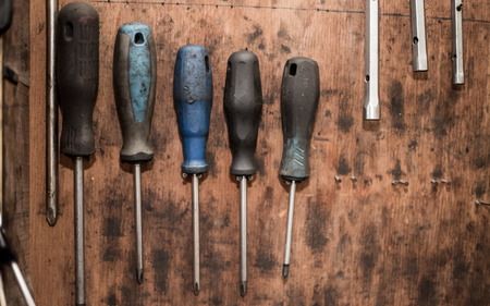 Mechanic, complex tool on the wall, like screwdrivers, private car service