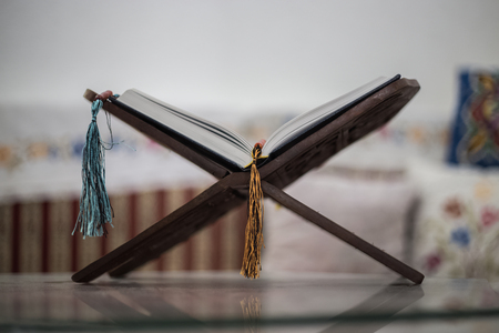 Quran-holy book of Muslims, an open book on a stand with rosaryの写真素材