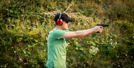 Profile of a brunette professional policeman killer special army forces training outside in the...