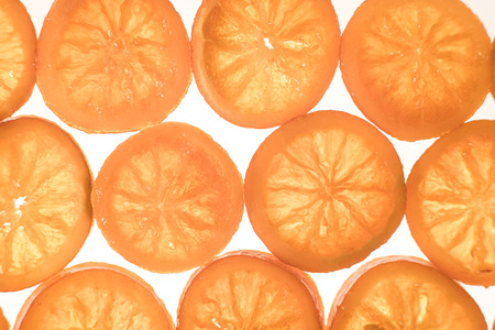Slices of caramelized oranges with top view. Can be used as christmas background