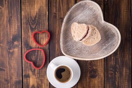 Sweet sandwiches cut in heart shape with red plum jam for Valentine's dayの写真素材