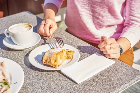 Woman eats desert on breakfast.の写真素材