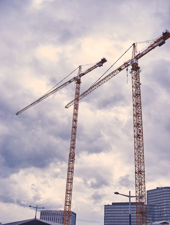 Modern housing development with cranesの写真素材