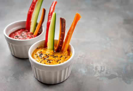 Close up of pumpkin dip with coroful vegetable sticks. Copy spaceの写真素材