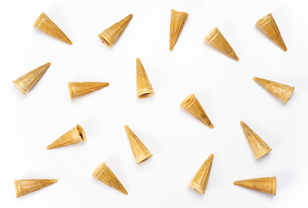 Flat lay of crispy waffle cones placed on white backgroundの写真素材