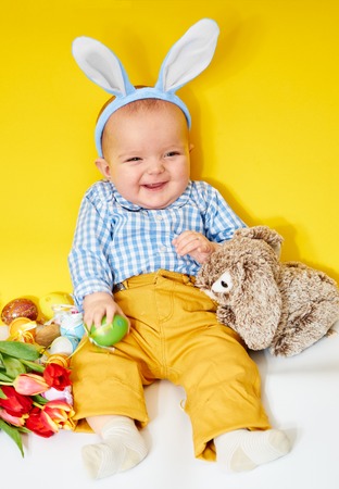 Happy baby boy with bunny earsの写真素材