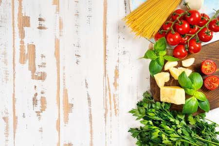 Top view of pan with ingredients for one pot spaghetti on white wooden backgroundの写真素材