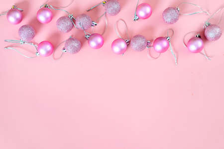 Top view of pink Christmas decorations on pink background. Copy spaceの写真素材