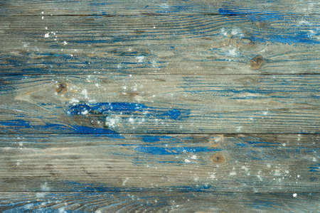 Top view of old grey wooden surface with blue and white paint stainsの写真素材