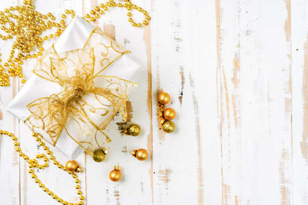 Topv view of golden Christmas gifts on white wooden backgroundの写真素材