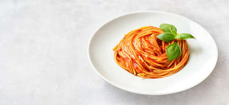 Pasta with tomato sauce and basil on white backgroundの写真素材