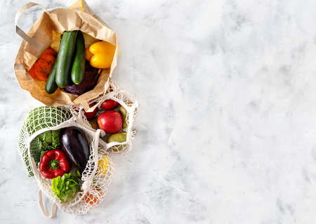 Top view of vegetables and fruits in reusable cotton net and paper bags. Zero waste concept. Copy spaceの写真素材
