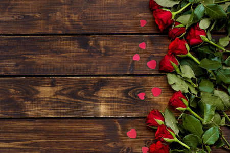 Red roses on a dark wooden background. Copy spaceの写真素材