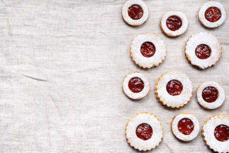 Top view of homemade linzer cookies on light wrinkled cloth for Christmas. Copy spaceの写真素材