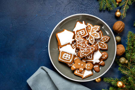 Top view of Christmas gingerbread in a plate on dark blue background. Winter holidays conceptの写真素材