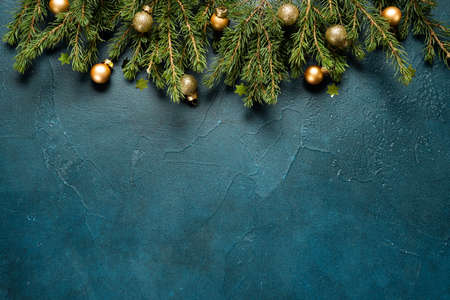 Christmas background with fir tree and decorations on deep mint backround on the upper rim of the shot. Top view with copy spaceの写真素材