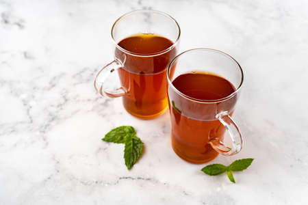 Two glass cups of black tea on white marmor background. Top viewの写真素材