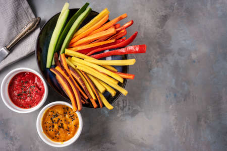 Top view of colorful vegetable sticks on gray backgroundの写真素材