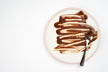 Top view of dirty plate with ice cream stains and fatの写真素材