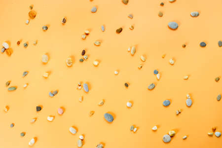 Top view of smal stones on yellow background