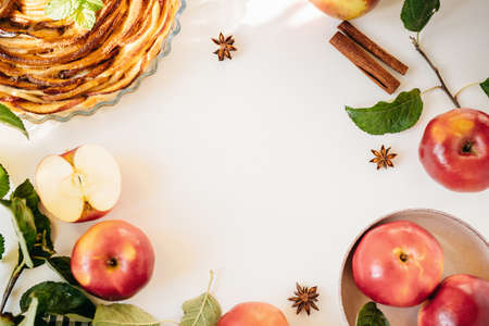 Top view of apples, spices and cake on white background with copy spaceの写真素材