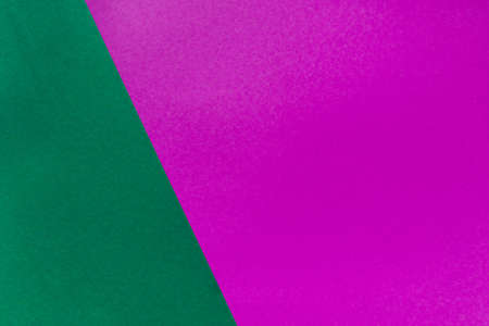 Vivid duotone green and velvet violet background. Top view. Color trends 2022