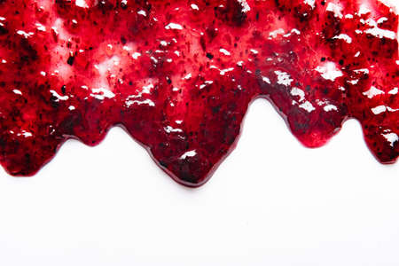 Sweet red jam spil isolated on white background. Abstract food background wiith copy space. Flat layの写真素材