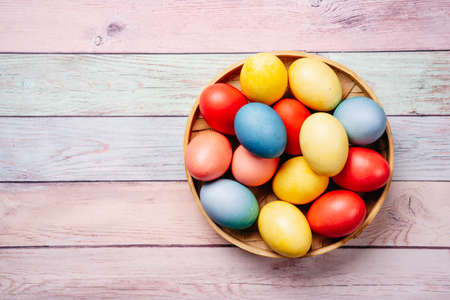 Easter eggs on pink wooden background with copy spaceの写真素材