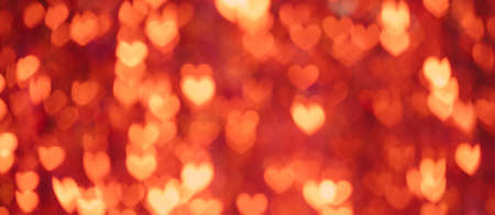 Valentines day abstract background with bright red bokeh hearts. Romantic concept. Lond banner