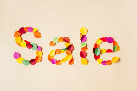 Top view of handmade paper autumn leaves forming text Sale. Autumn season and sales. Paper art and handcraftingの写真素材