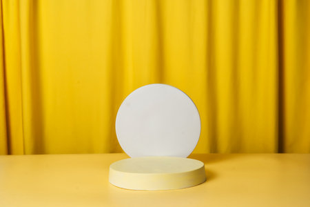 Abstract round podium, pedestal on a bright yellow curtain background. Empty showcase. Product, promotion sale, presentation, beauty cosmetic. Easter holidaysの写真素材