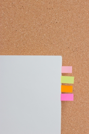 Sticking reminder on notepad with cock-board の写真素材