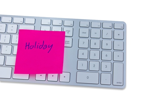 Holiday concept with computer keyboard and note with holiday の写真素材