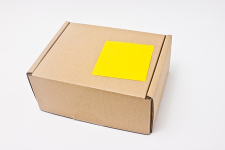 Blank yellow sticky note post on paper box  の写真素材