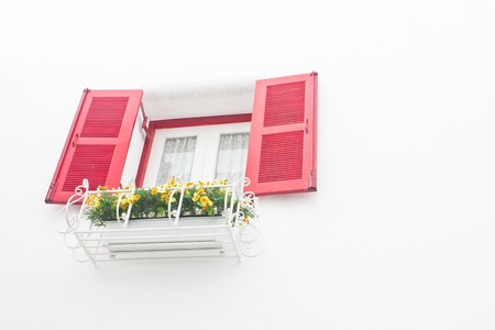 Red open window with white wall 